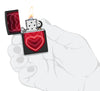 Zippo Black Light Hearts Design Black Matte Pocklet Lighter lit in hand.